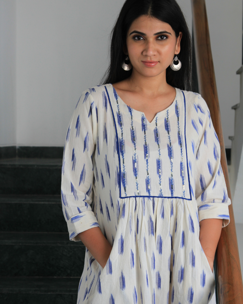 White ikat dress with embroidered yoke and front pockets