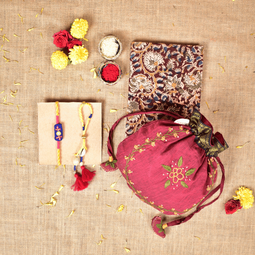 Bhai Bhabhi Raksha Bandhan Gift Combo – Rakhi Set with Handloom Diary & Feather Embroidery Potli