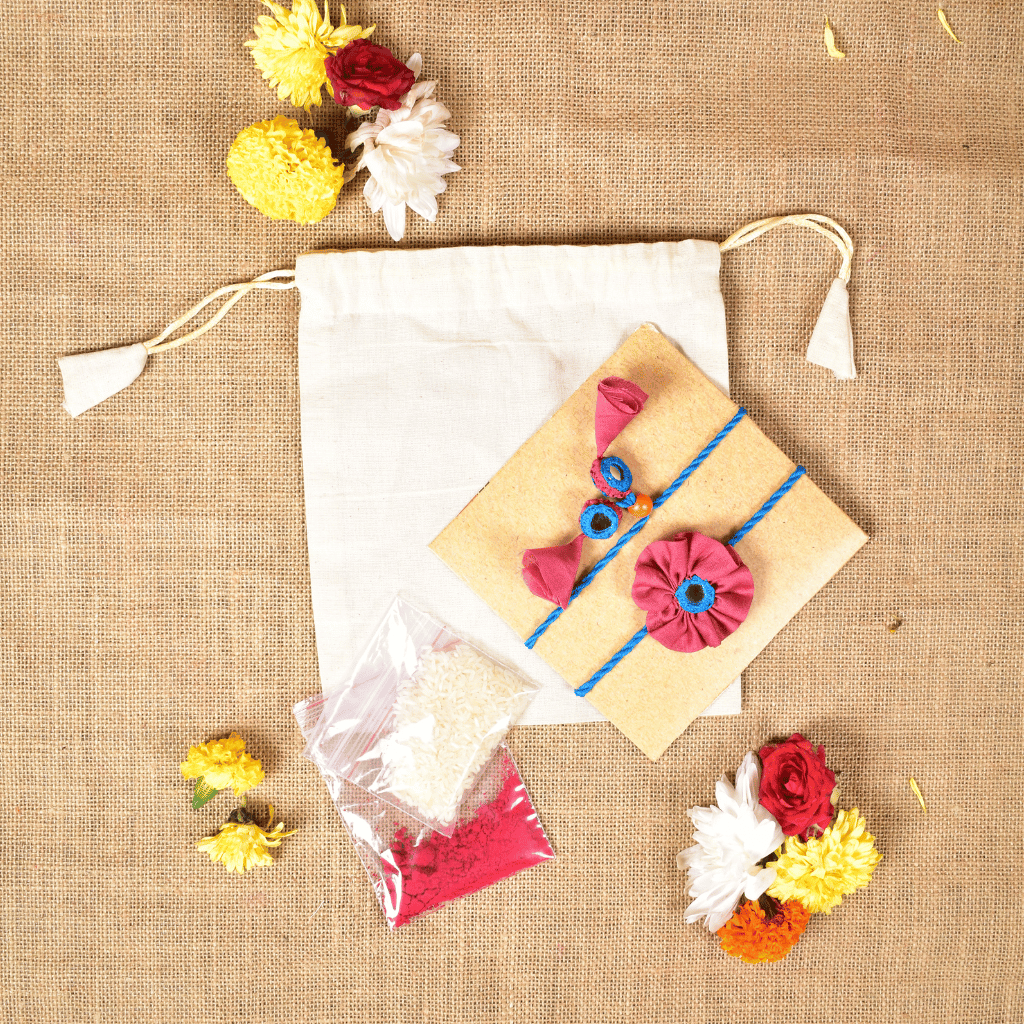 Handcrafted Bhai Bhabhi Flower Rakhi Set with Cotton Potli, Kumkum & Rice - Pink