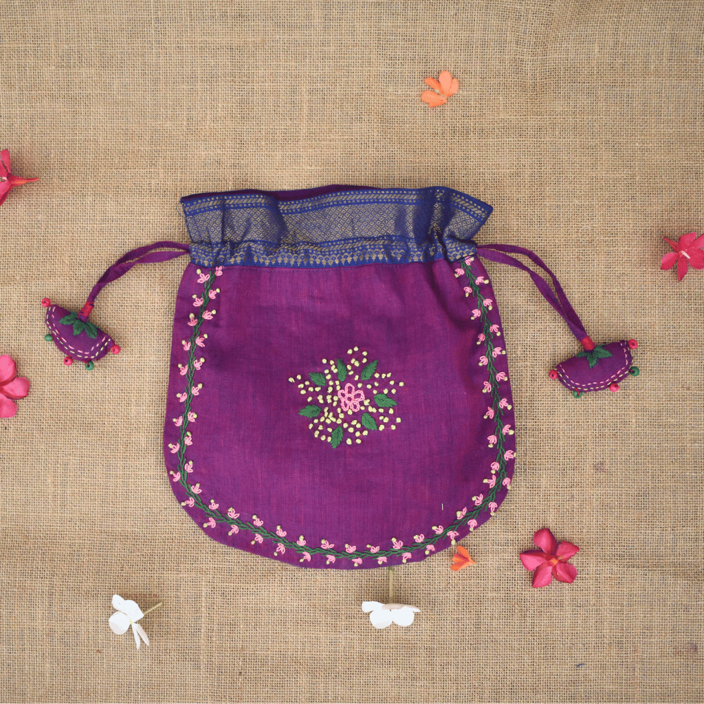 Festive purple potli bag with feather stitch embroidery and handmade tassels