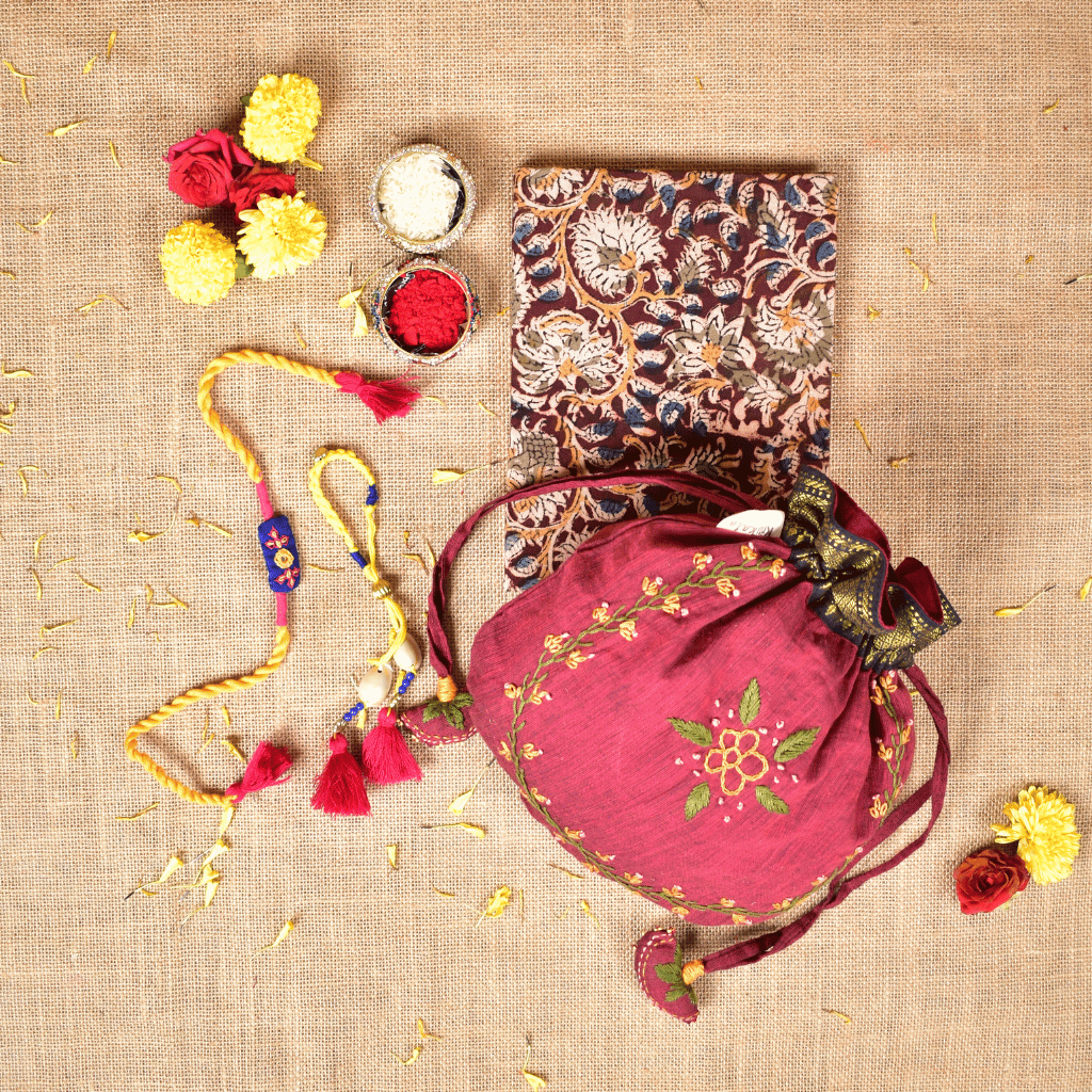 Bhai Bhabhi Raksha Bandhan Gift Combo – Rakhi Set with Handloom Diary & Feather Embroidery Potli