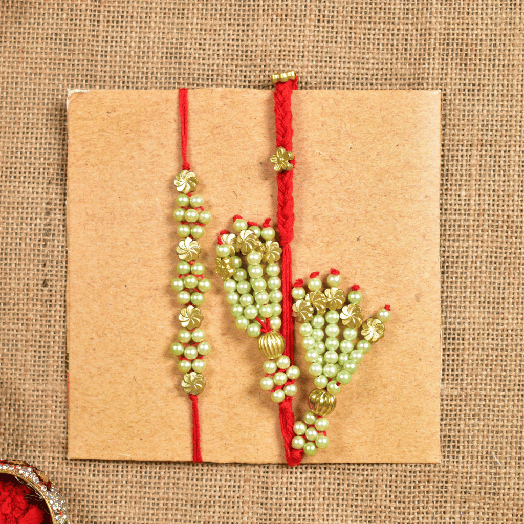 Pearl Bhai Bhabhi Rakhi Set with Golden Floral Beads & Cotton Potli