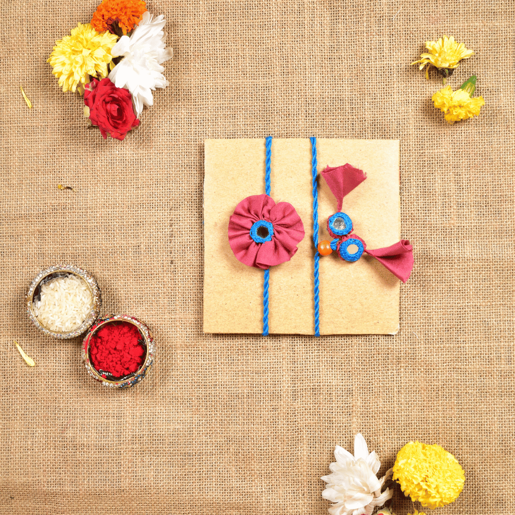 Handcrafted Bhai Bhabhi Flower Rakhi Set with Cotton Potli, Kumkum & Rice - Pink