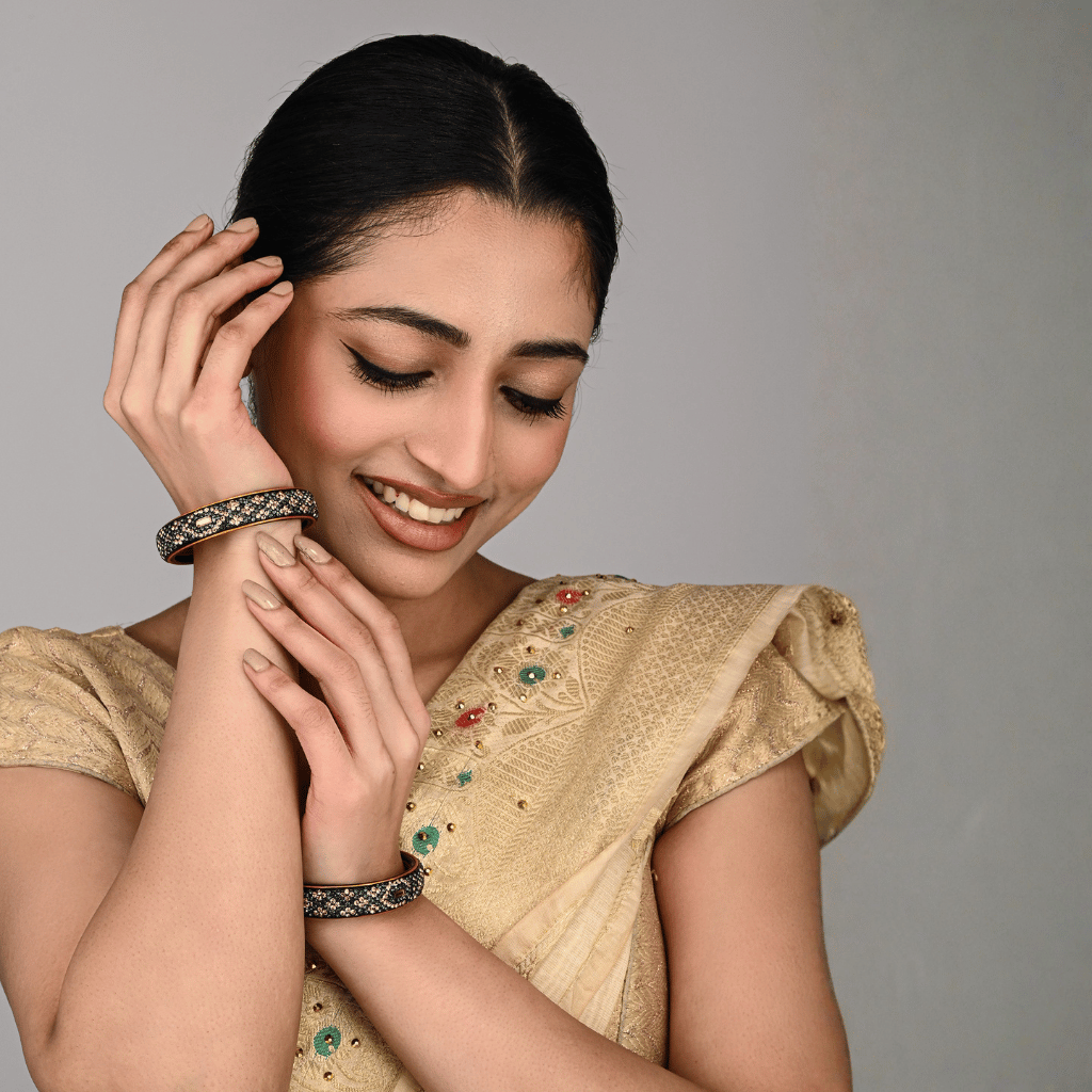 Pair of broad lac bangles in golden and black tones