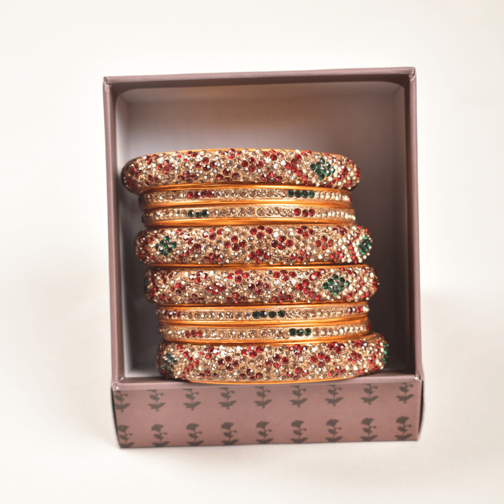 Pair of lac bangles in maroon & gold stones - front