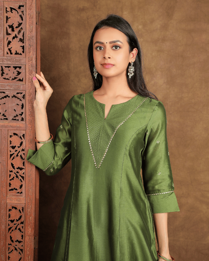 Fida A line Chanderi Silk Kurta and Pant Set with a v shaped yoke and kalis in Moss Green