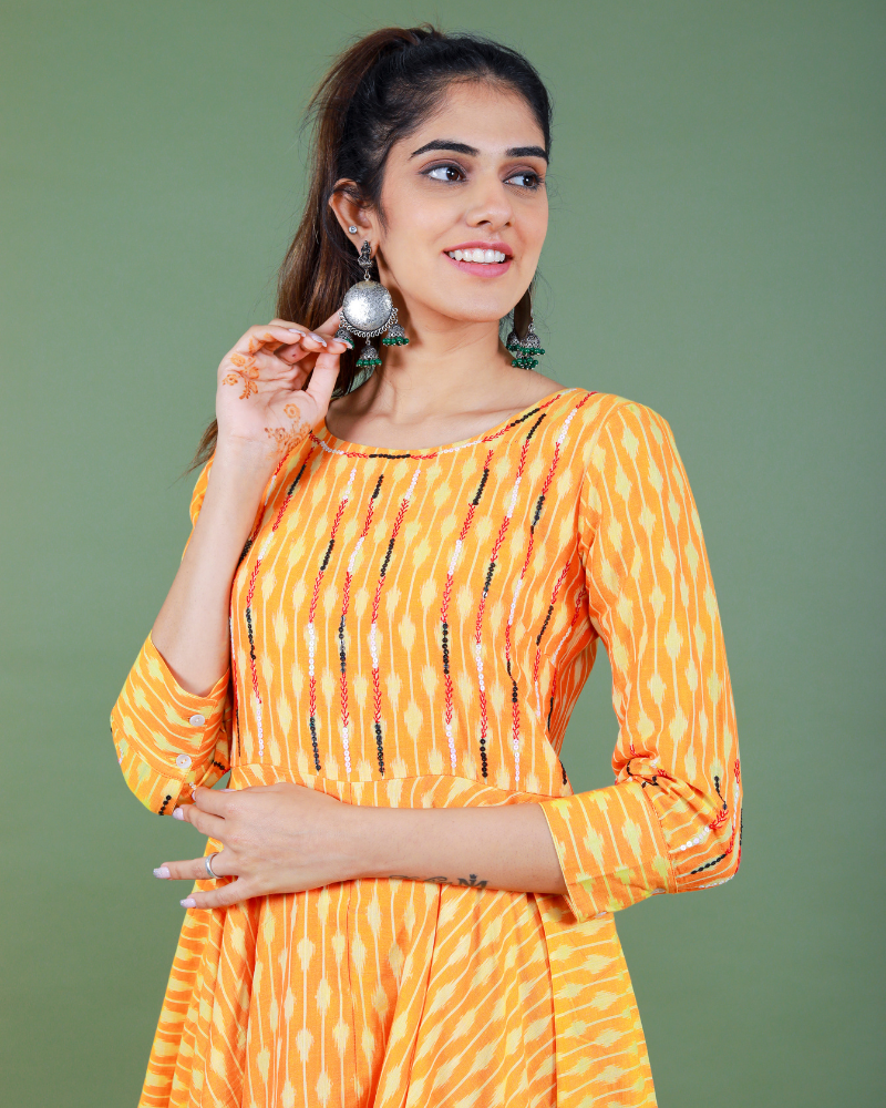Golden yellow semi silk ikat dress with a handkerchief hem