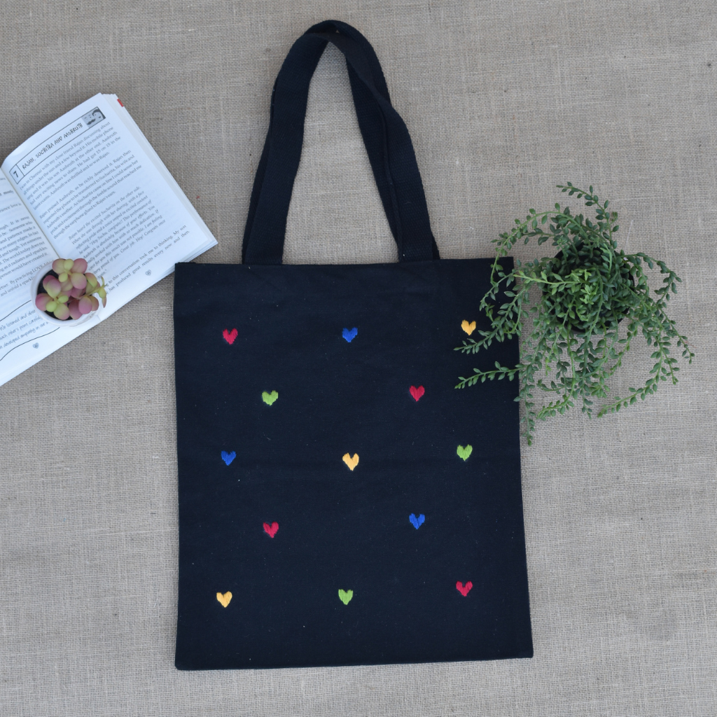 Black canvas tote bag with small hearts embroidery