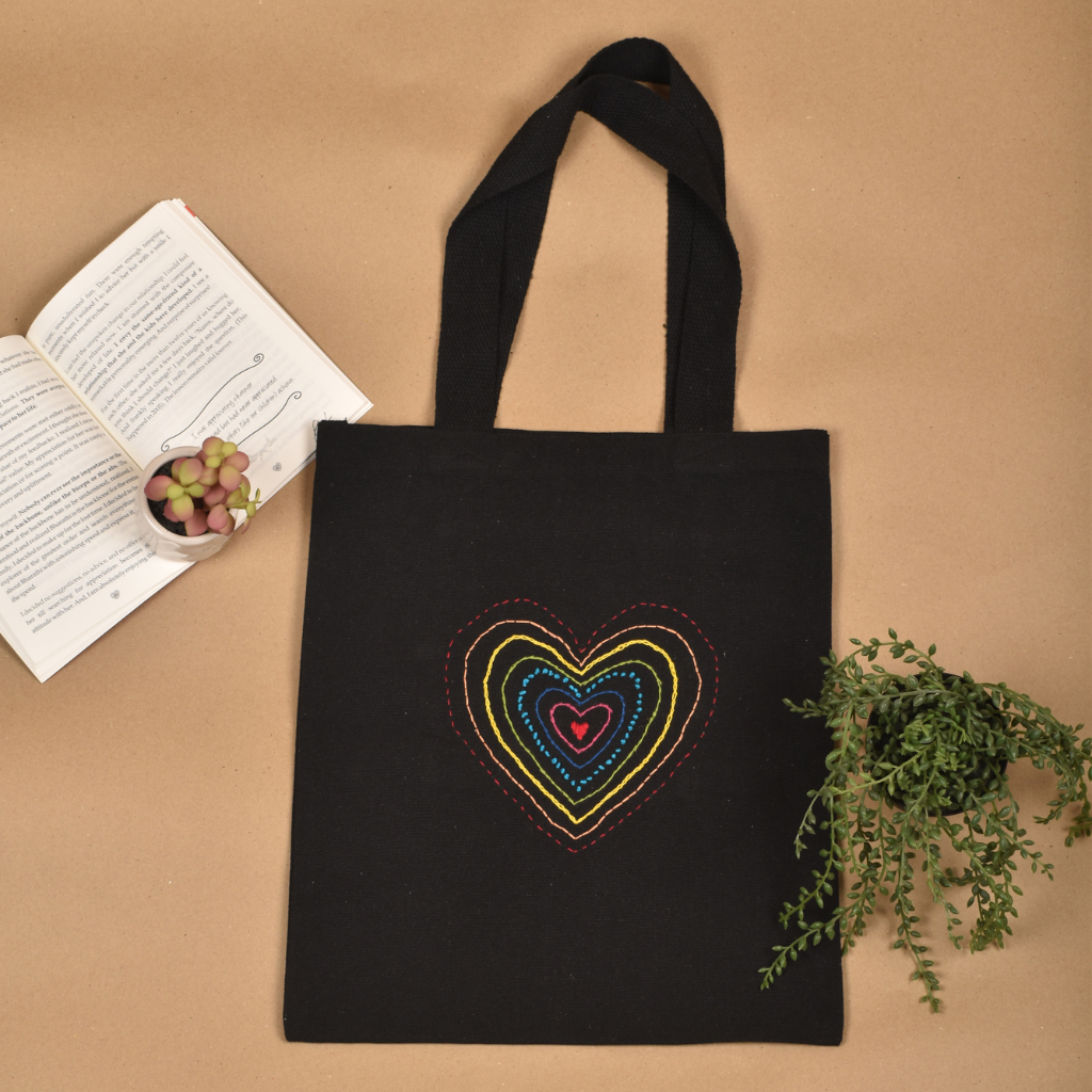 Black canvas tote bag with heart embroidery - front