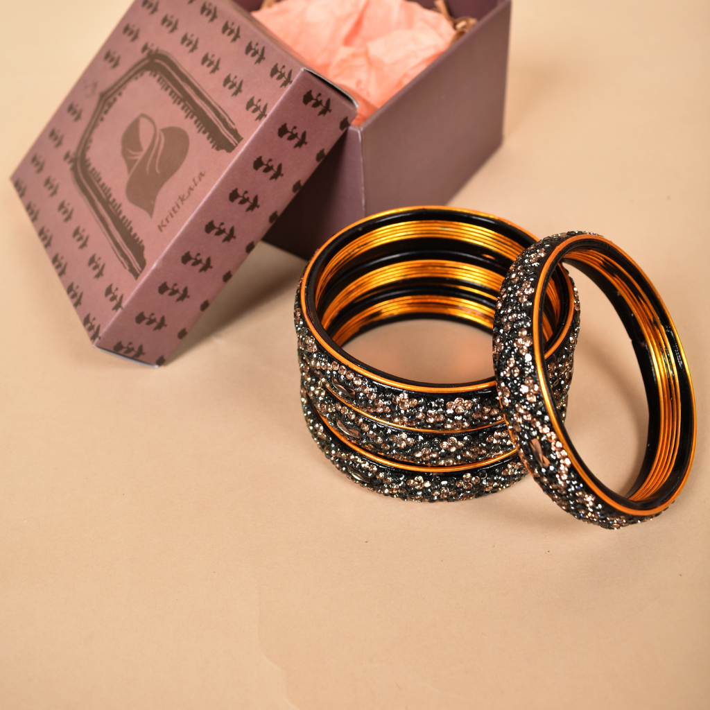 Pair of broad bangles in golden and black tones