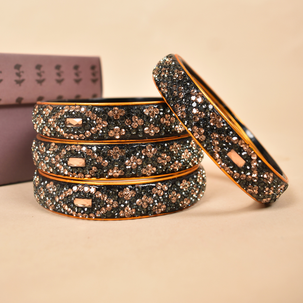 Pair of broad bangles in golden and black tones