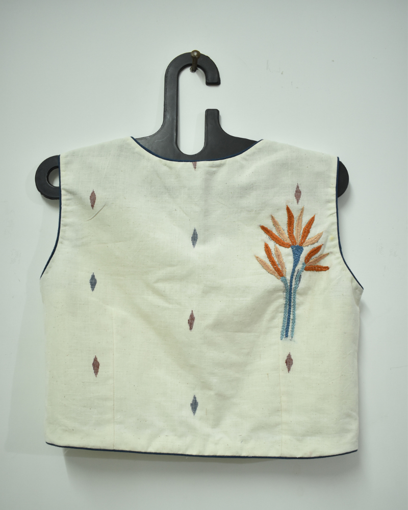 Sleeveless offwhite saree blouse with orange flower motif