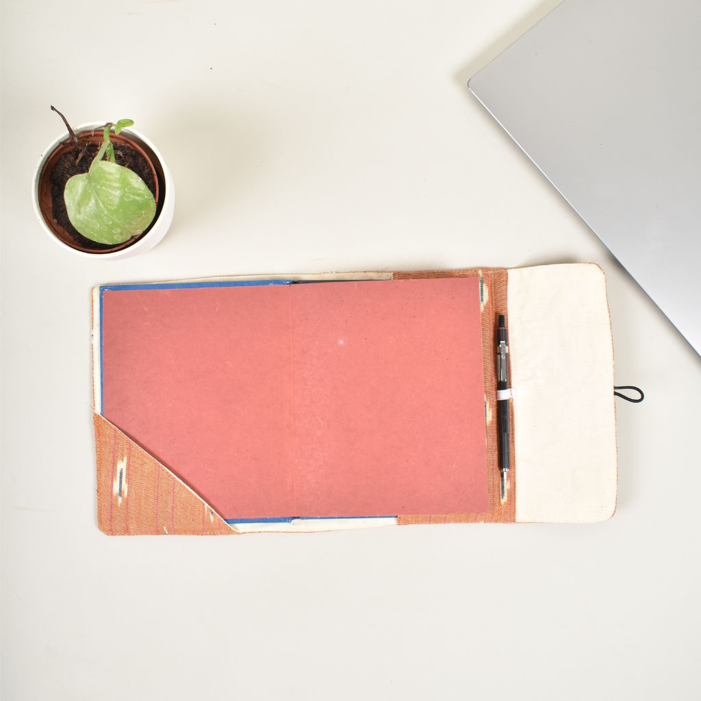 Orange journal sleeve with white cotton lining and  a handmade paper diary - closure