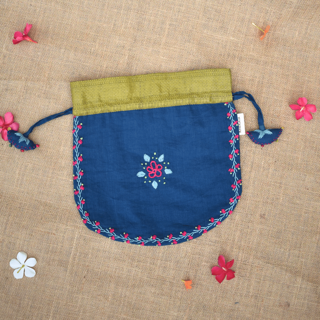 Festive blue potli bag with feather stitch embroidery and handmade tassels