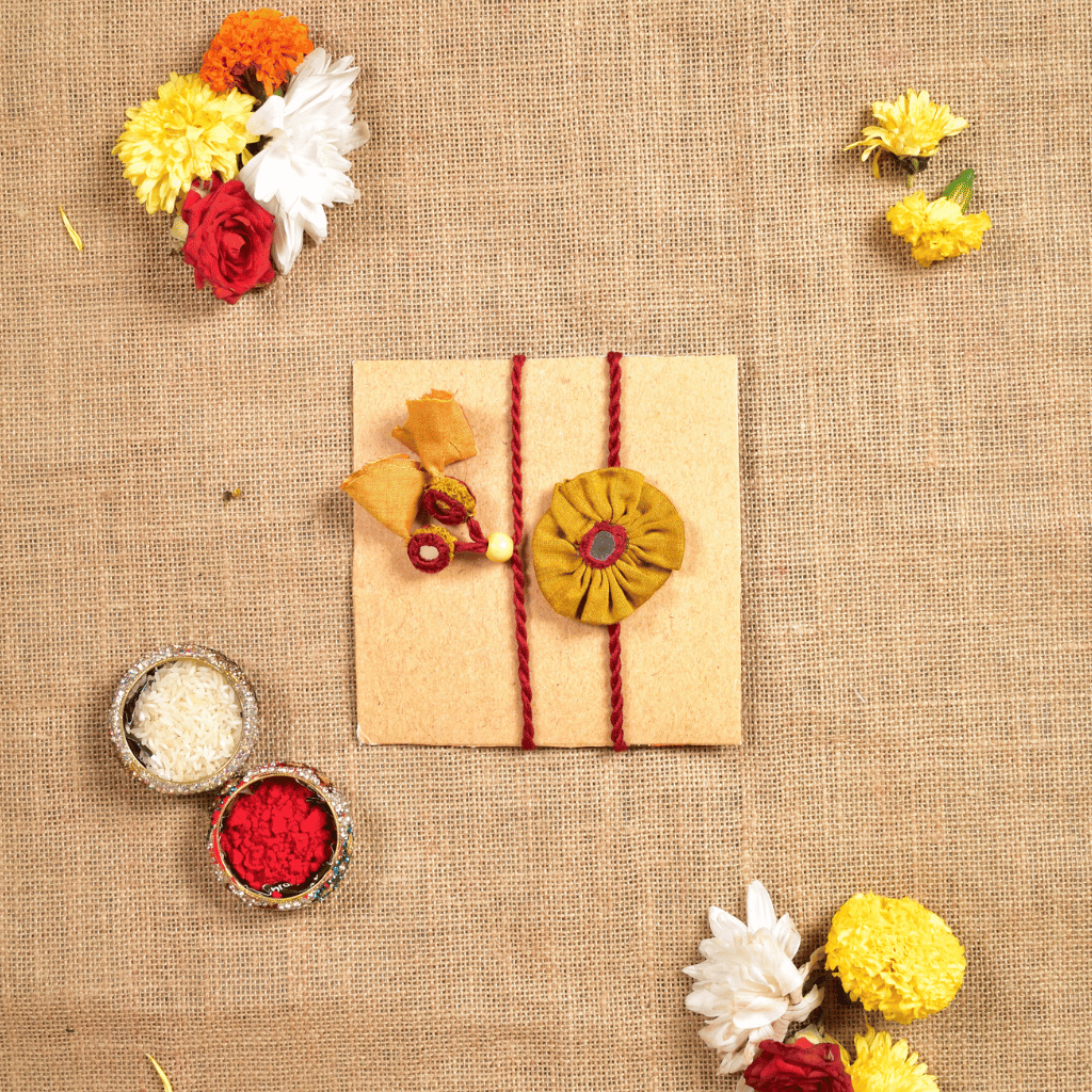 Handcrafted Bhai Bhabhi Flower Rakhi Set with Cotton Potli, Kumkum & Rice - Yellow
