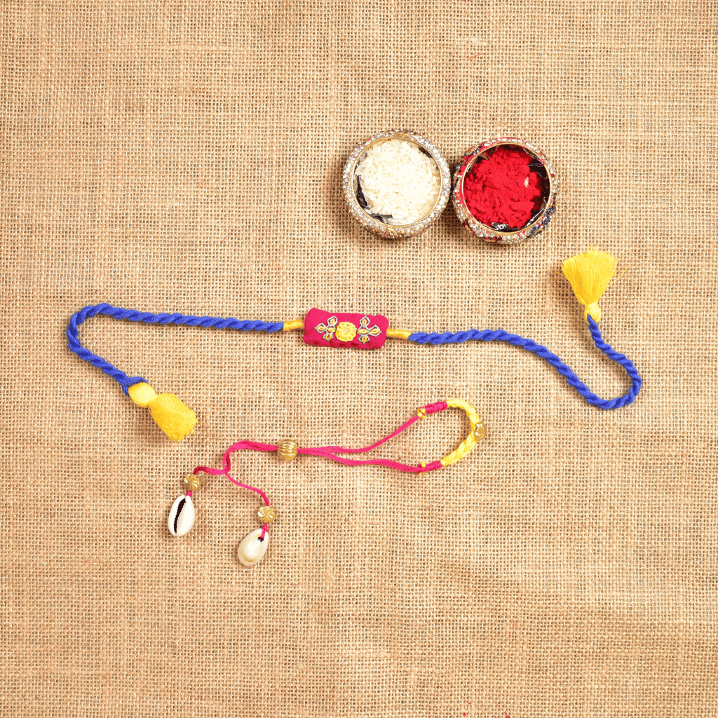 Handcrafted Bhai Bhabhi Rakhi Set with Cotton Potli, Kumkum & Rice - Pink