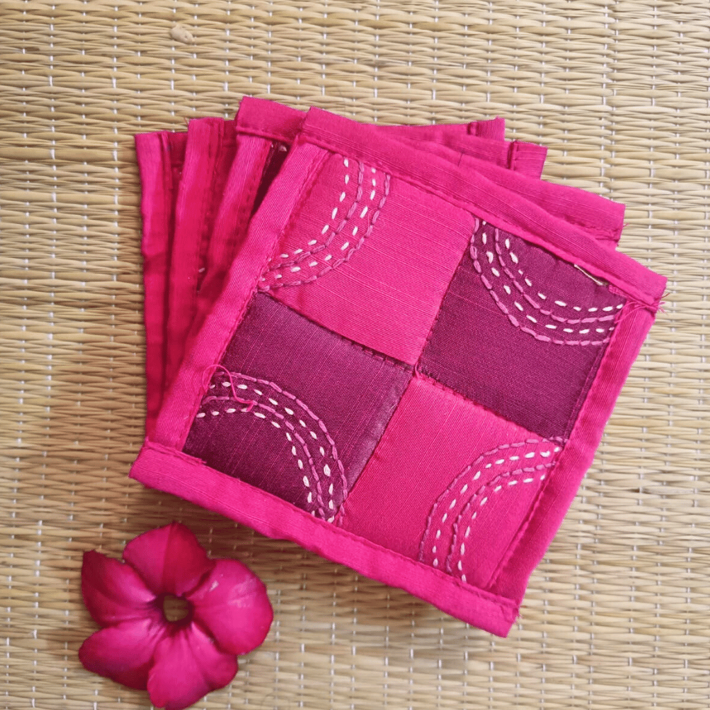 Handmade pink and maroon patchwork coaster with embroidery