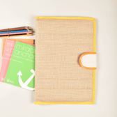 Simple natural jute file folder with a velcro tab and yellow piping - front