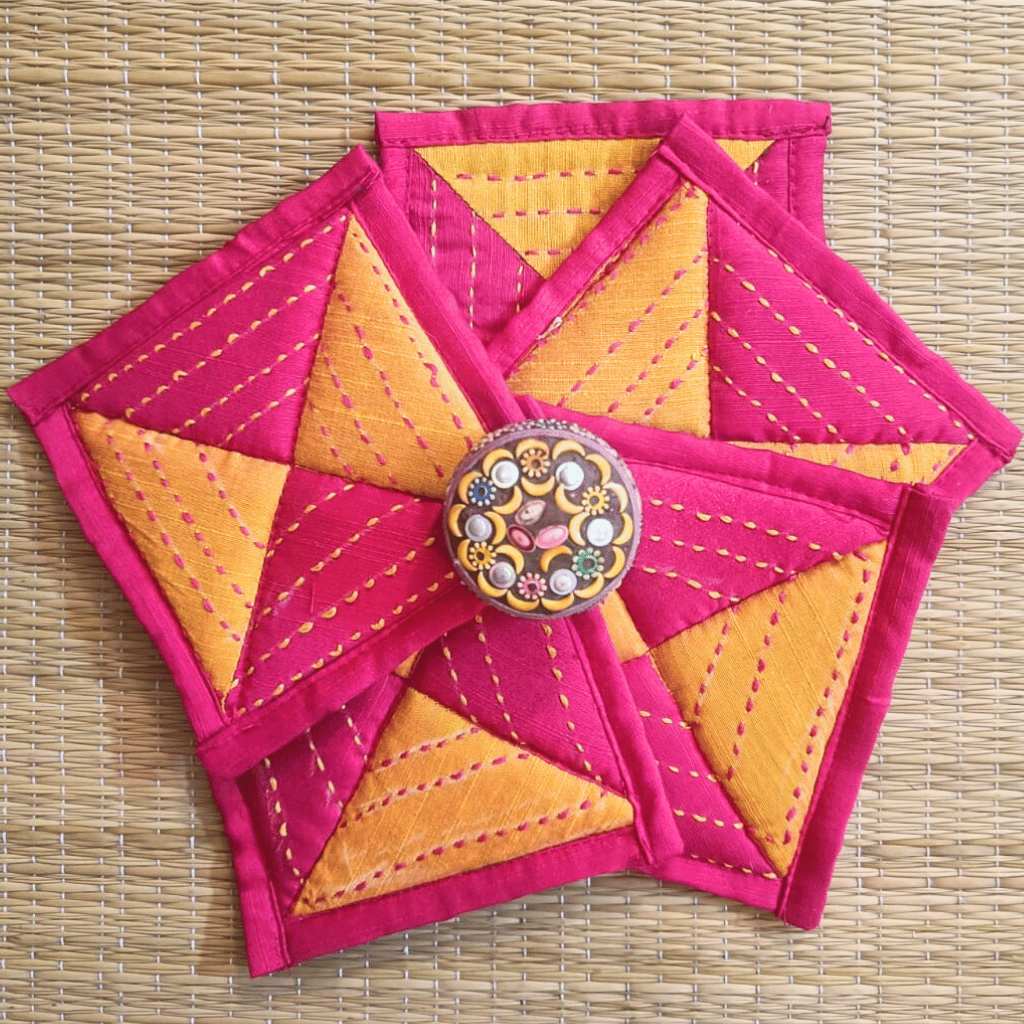 Handmade magenta and yellow patchwork coaster with embroidery
