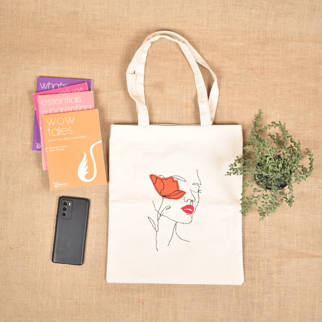 White Canvas Tote Bag with Embroidered Face & Flower Design - front