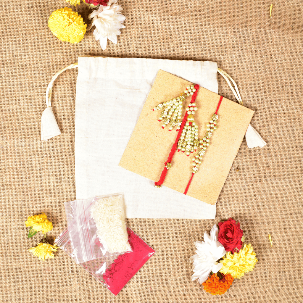 Pearl Bhai Bhabhi Rakhi Set with Golden Floral Beads & Cotton Potli