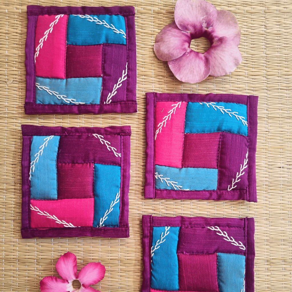 Handmade blue and maroon patchwork coaster with embroidery