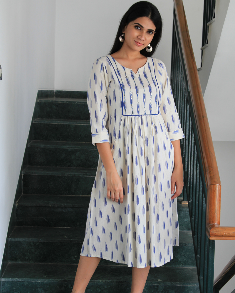 White ikat dress with embroidered yoke and front pockets