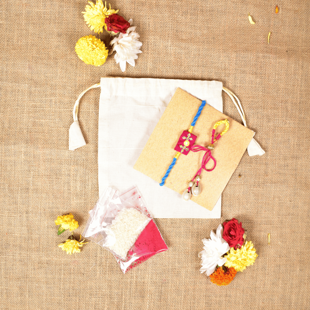 Handcrafted Bhai Bhabhi Rakhi Set with Cotton Potli, Kumkum & Rice - Pink
