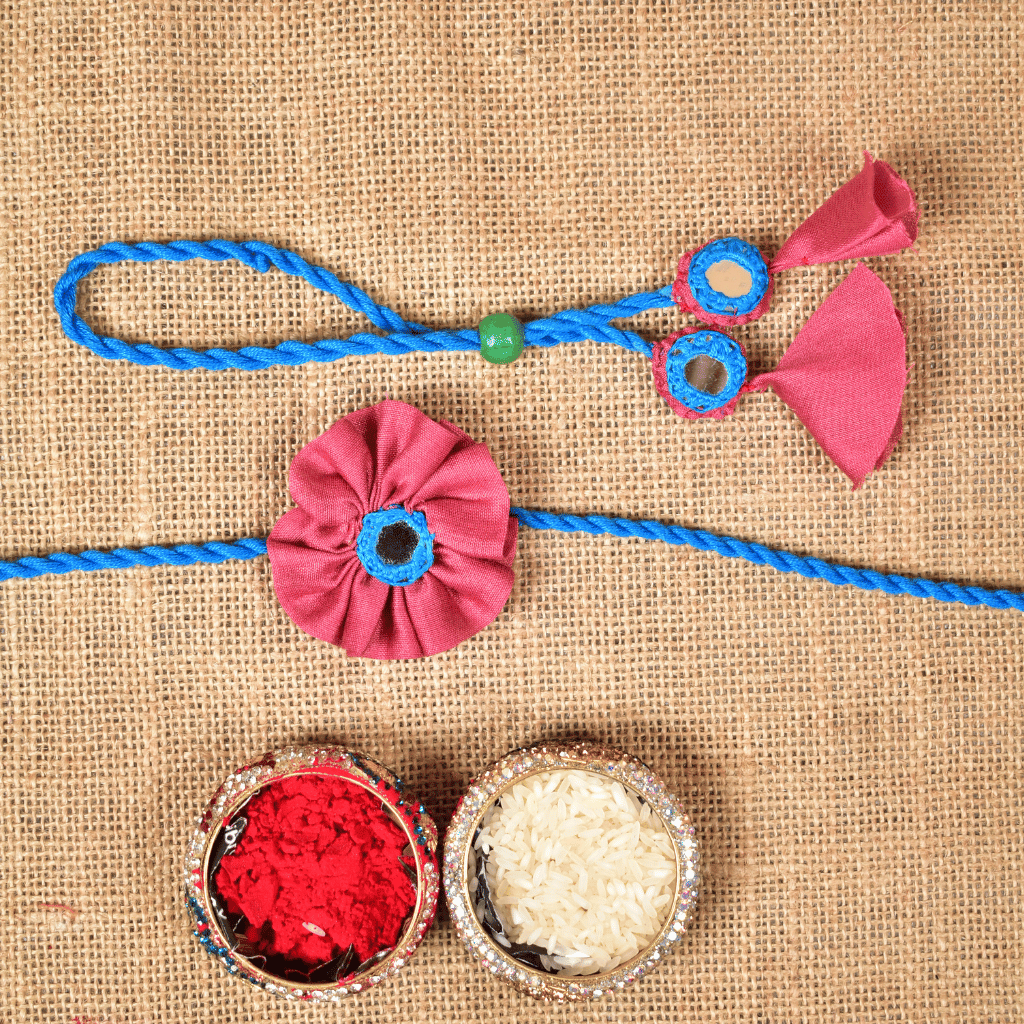 Handcrafted Bhai Bhabhi Flower Rakhi Set with Cotton Potli, Kumkum & Rice - Pink