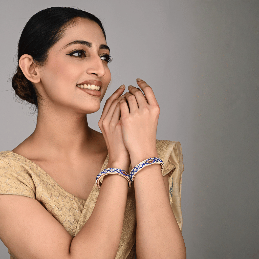 Pair of broad bangles in white and blue tones 