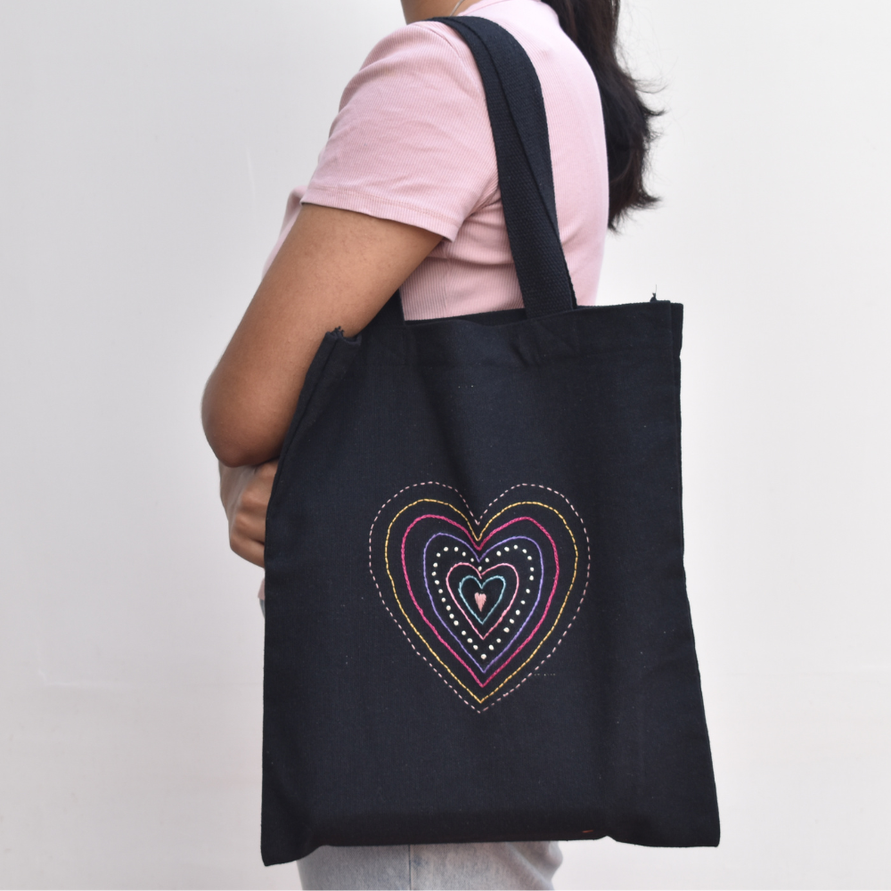 Black canvas tote bag with heart embroidery