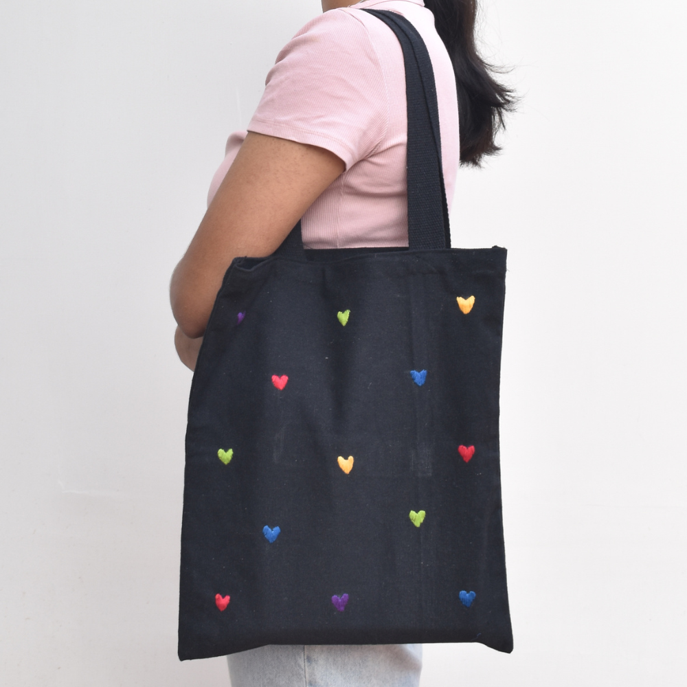 Black canvas tote bag with small hearts embroidery