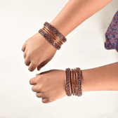 Pair of lac bangles in red & green stones