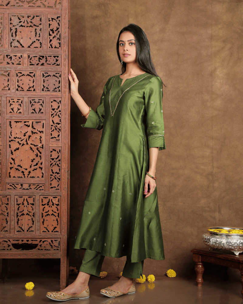 Fida A line Chanderi Silk Kurta and Pant Set with a v shaped yoke  and kalis in Moss Green