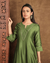 Fida A line Chanderi Silk Kurta and Pant Set with a v shaped yoke  and kalis in Moss Green