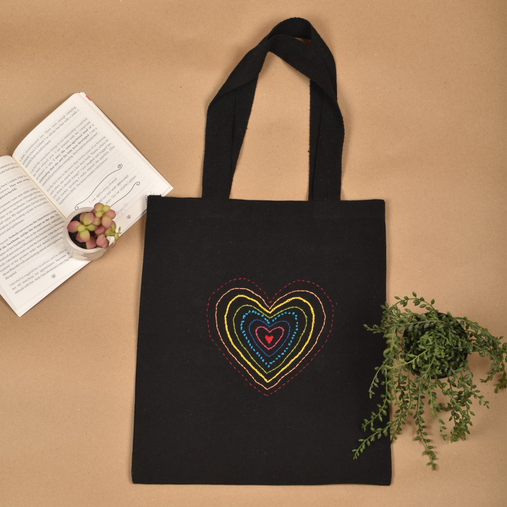 Black canvas tote bag with heart embroidery