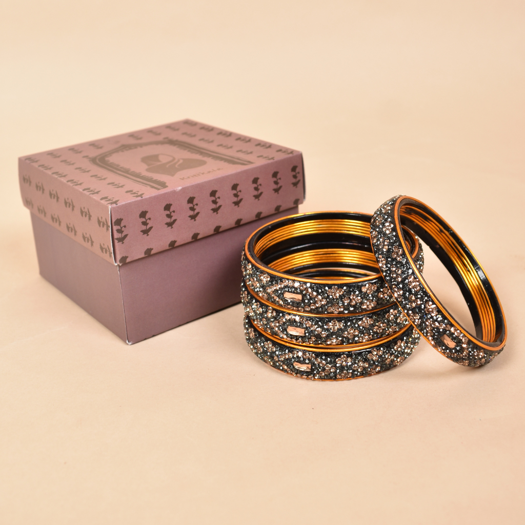 Pair of broad bangles in golden and black tones