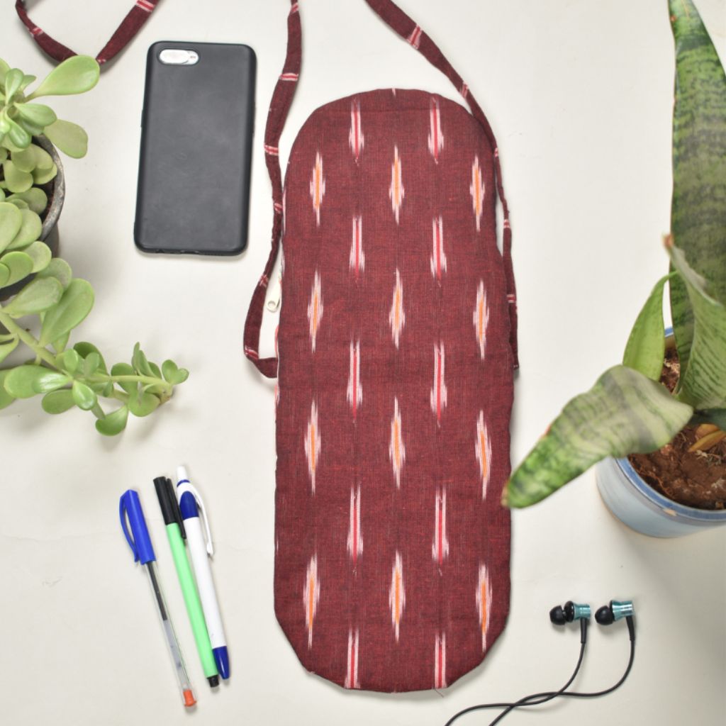 Multi-pocket sling bag in maroon ikat cotton