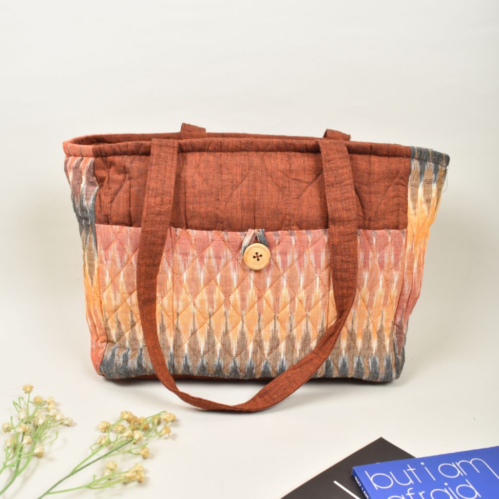 Quilted handbag in rust and maroon ikat with multiple pockets 
