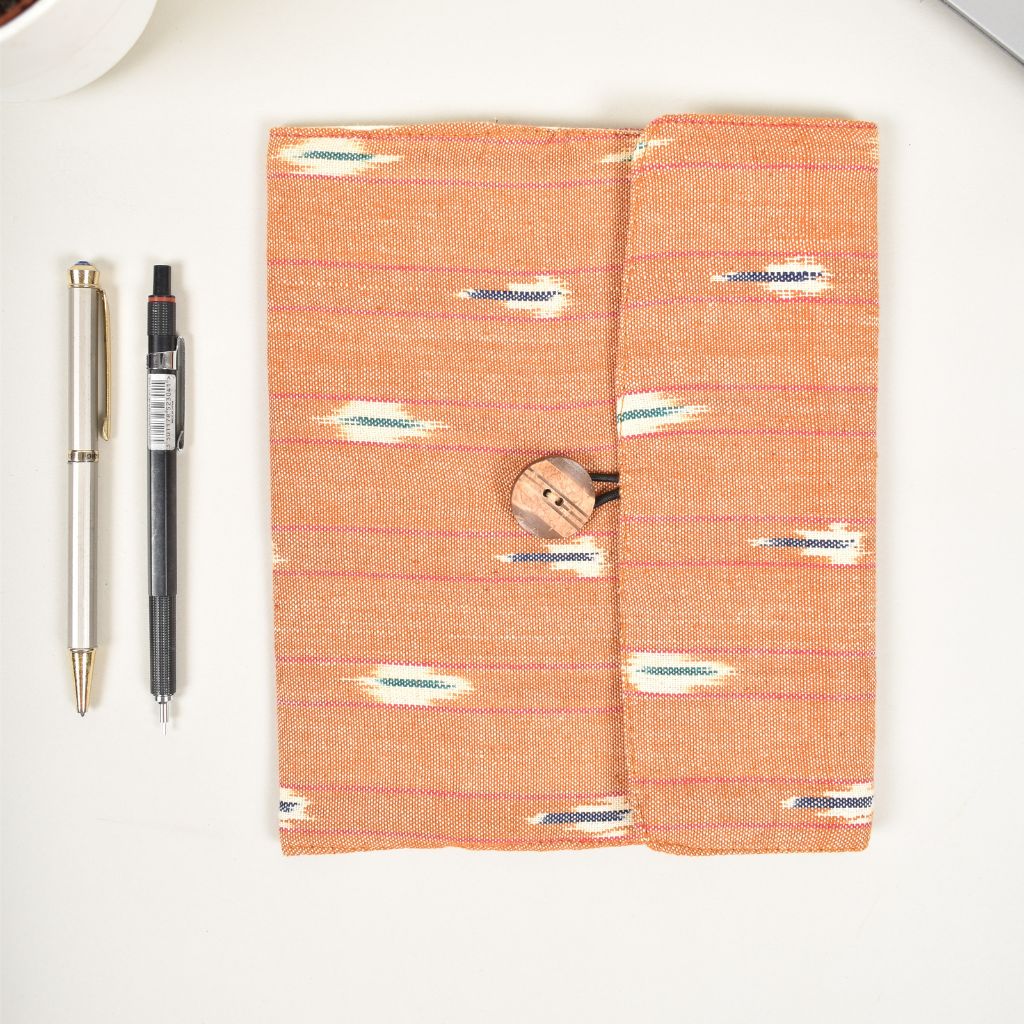 Orange journal sleeve with white cotton lining and  a handmade paper diary